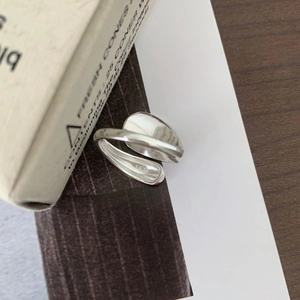 Macro shot of minimalist S925 sterling silver open ring with polished liquid metal design