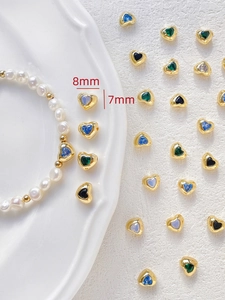Close-up of 18k gold-plated heart beads with colorful zircon used in pearl bracelets