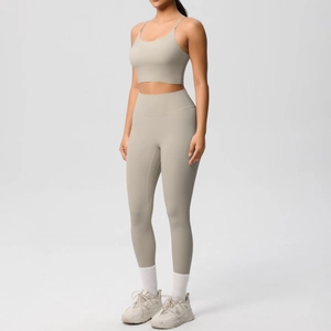 Detailed close-up of high-waist seamless leggings and thin strap sports bra set in beige