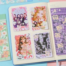 Close-up of K-pop star photo cards featuring Rosé and Lisa on a minimalist journal