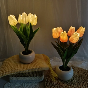 Close-up of LED tulip night light in a ceramic pot with soft petals and warm glow