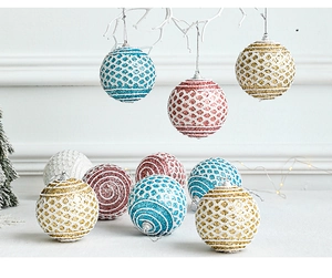 Detailed view of colorful Christmas balls with lace mesh and glitter on white branches