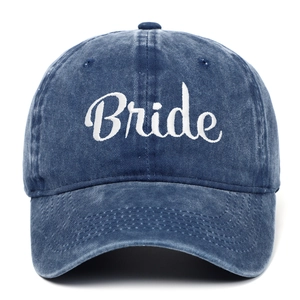 Close-up of white Bride embroidery on vintage washed blue cotton baseball cap texture