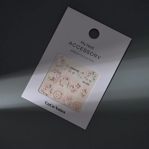 Detail of 3D embossed floral nail art stickers with pearls and bear motifs on white card