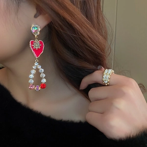 Close-up of long tassel butterfly earrings with colorful crystals and rhinestone details