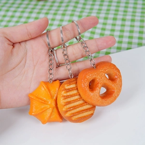 Three-piece simulation food keychain set with pretzel and bread shapes on key rings