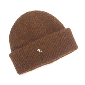 Close-up of deep brown ribbed knit beanie with cream cursive R letter embroidery detail