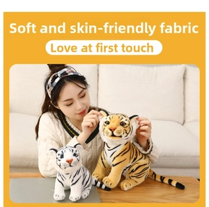 Detailed view of soft lifelike tiger plush toys in yellow and white striped patterns