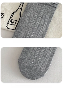 Close-up detail of reinforced heel and seamless toe on grey ribbed cotton socks