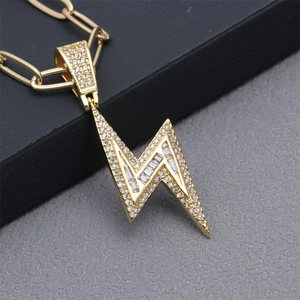 Close-up of golden lightning bolt pendant with micro-pave cubic zirconia on chain