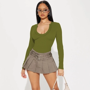 Detail of olive green knit long sleeve bodysuit and grey pleated skirt with double belt buckles