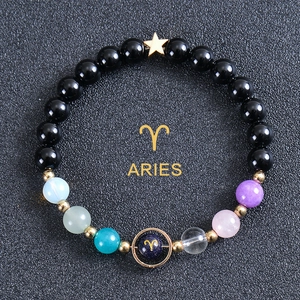 Detail of Aries constellation bracelet with blue sandstone beads and gold star pendant