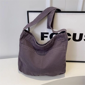 Minimalist purple canvas tote bag with front pocket and wide shoulder strap