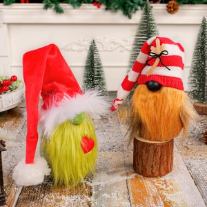 Christmas gnomes set with red heart hat and green fur body on rustic wood base