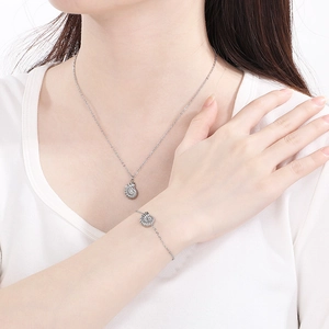 Close-up of silver stainless steel sea shell necklace and bracelet on model