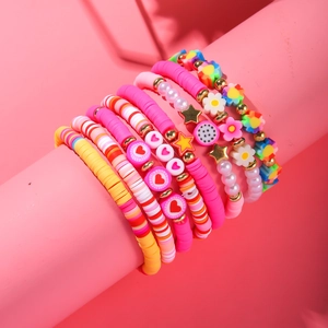 Detailed view of bohemian colorful beaded bracelet set with hearts and floral charms