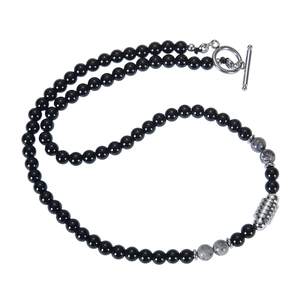 Macro shot of 6mm natural tiger eye and obsidian beads with silver toggle clasp