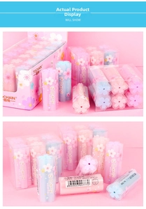 Macro detail of cherry blossom shaped erasers in pink and blue gift box packaging