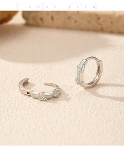 Detailed close-up of S925 sterling silver butterfly hoop earrings with mint green enamel