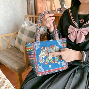 Ethnic blue canvas tote bag with elephant embroidery and colorful geometric straps