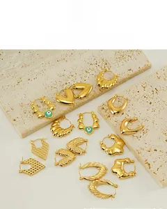Detailed display of 18K gold plated earrings featuring heart and evil eye designs