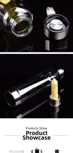 Close-up of the detachable stainless steel base and yellow crystal prism inside glass bottle