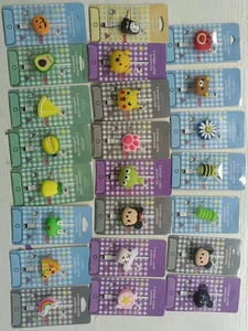Detailed grid of diverse cartoon PVC cable protectors with colorful character shapes