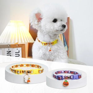 Detail of adjustable Halloween pet collars with pumpkin charms in orange and purple