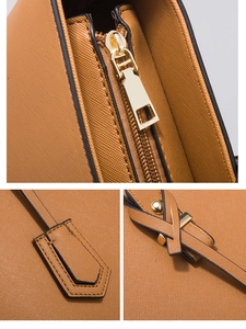 Detailed close-up of premium brown PU leather texture and gold-tone hardware zipper