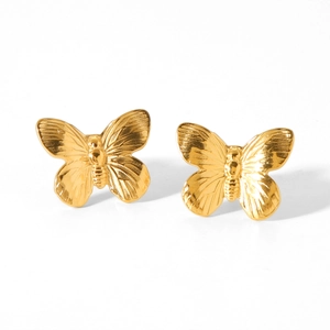 Detail of gold butterfly stud earrings with delicate embossed texture on white background