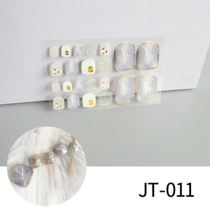 Close-up of JT-011 3D toenail stickers with purple marble texture and gold foil edges