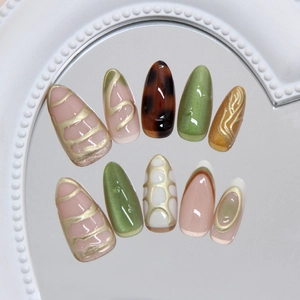 Press on nails with golden lines, emerald cat eye effect and tortoiseshell patterns