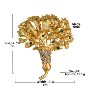 Detailed view of flower brooch with blue and green rhinestones in matte gold finish