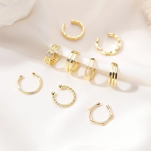 8-piece set of gold-plated C-shaped ear cuffs featuring textured and layered metal designs