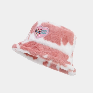 Close-up of pink cow print plush bucket hat featuring a cute heart cat embroidery patch