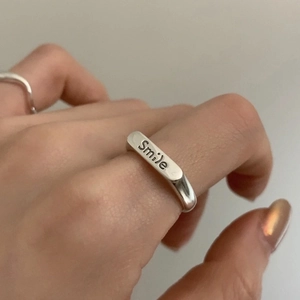 Detail of 925 sterling silver smile ring shown on hand with minimalist aesthetic
