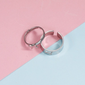 Polished silver stainless steel couple rings with hollow butterfly design in split background
