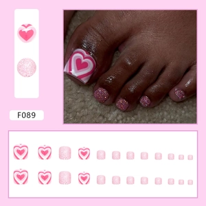 Pink glitter press-on toenails featuring heart patterns and sparkling sequins set