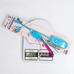 Blue laser cat wand with feathers and ribbons, size 37x8x3.4cm on a digital scale