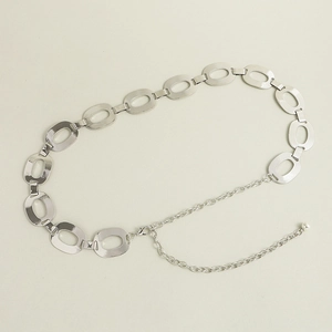 Detail of silver oval metal waist chain with adjustable lobster clasp and ball pendant