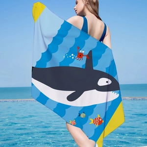 Orca and sea creature print microfiber beach towel displayed by a pool with ocean view