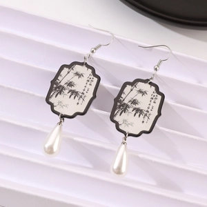 Detail of fan-shaped earring with bamboo ink painting and white teardrop pearl pendant