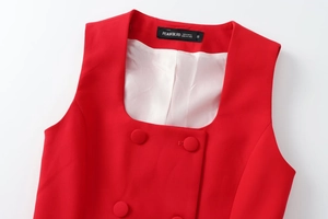 Detail of red square neck vest featuring double-breasted buttons and white satin lining