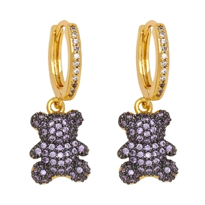 Detail of gold teddy bear earrings featuring lavender and white zircon pavé setting