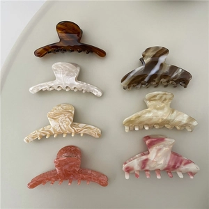 Medium acetate hair claws in tortoise, marble, and cream finishes, 7-piece color display