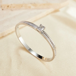 Detail of silver stainless steel bangle with square zircon and white mother of pearl inlay
