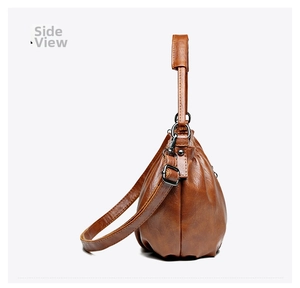Side view of brown pleated crossbody bag with premium pebble grain texture and metal hardware