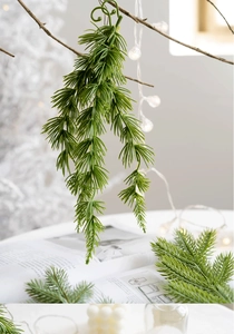 Macro detail of artificial pine needle branch with hooks for Christmas wreath DIY