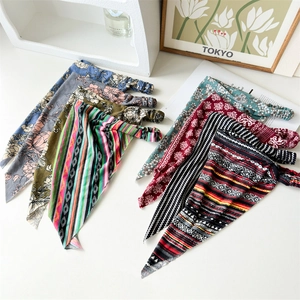 Detail of diverse patterned cotton triangle headbands with elastic floral and striped fabrics