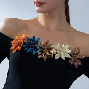 Elegant acrylic flower brooches with tassels on black off-shoulder top in five vibrant colors